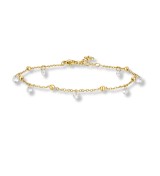 Tobillera de acero dorado con colgantes de circonitas brillantes y diseño elegante para mujer.